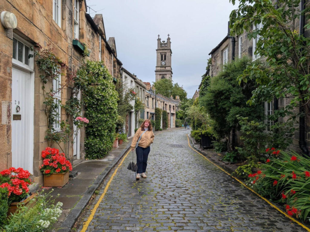 The author Louise Wylie standing along the beautiful buildings around the Circus Lane