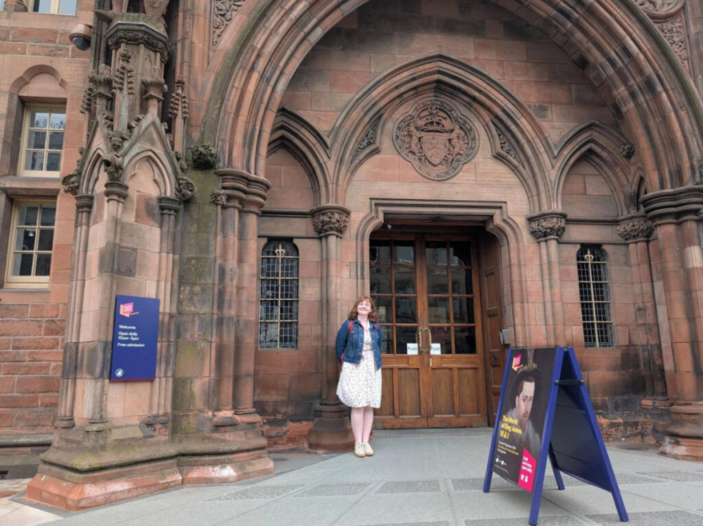 The author Louise Wylie standing for a photo at the entrance of Neo-Gothic National Gallery