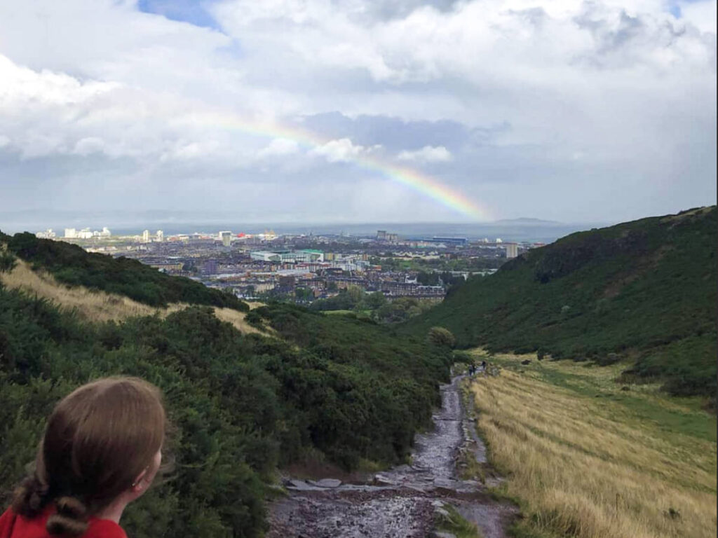 The author Louise Wylie enjoying the view of the rainbow over Leith