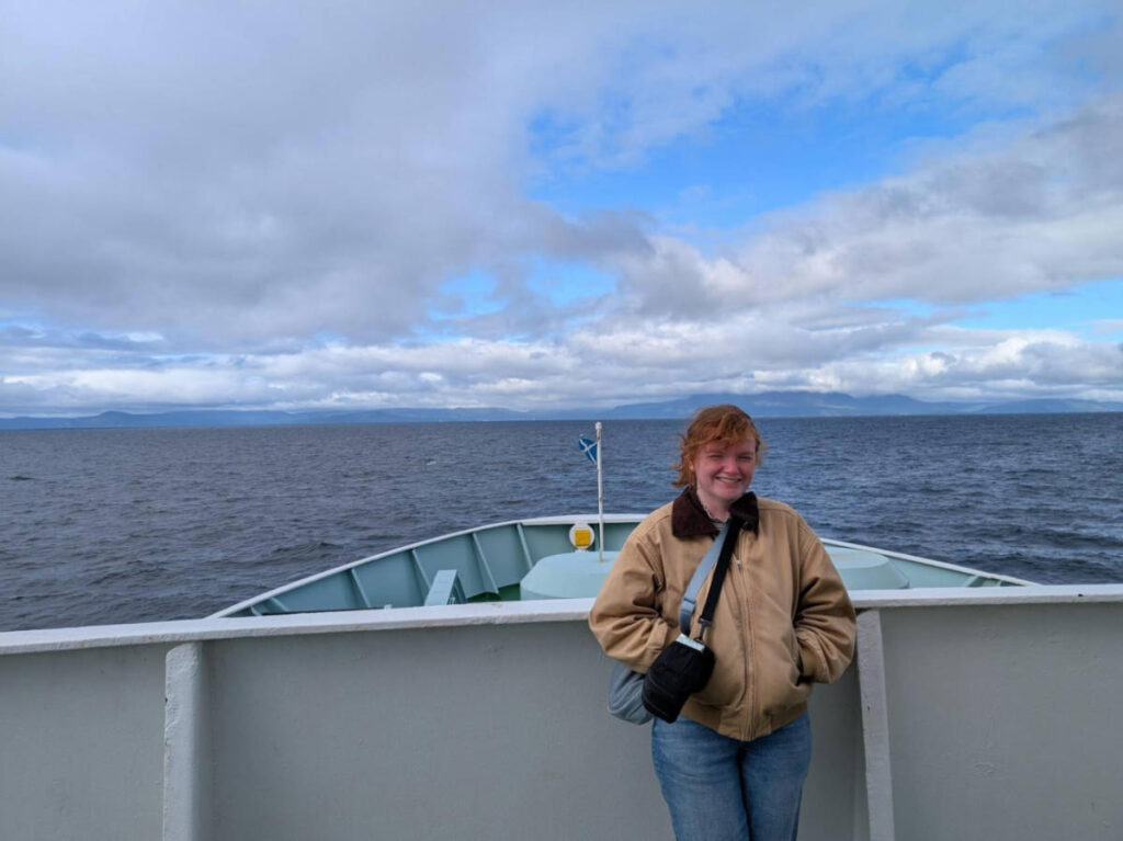 Travel Lemming writer Louise Wylie standing on the Ferry to Arran