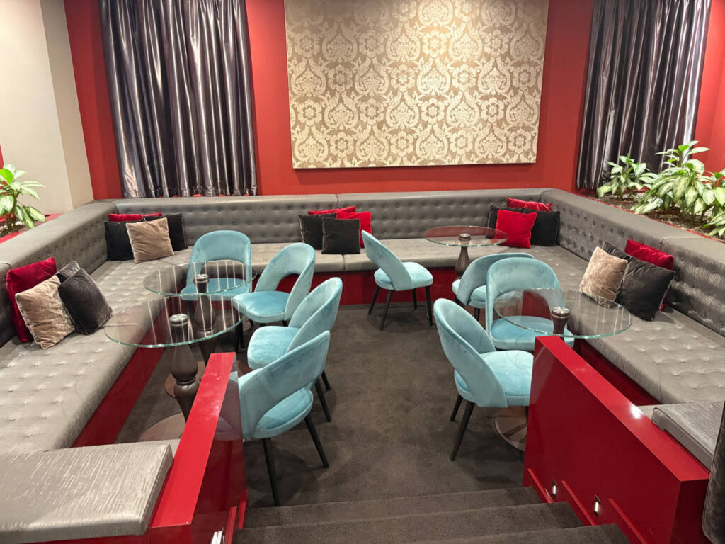 View of chairs and tables at the lounge area in Leonardo Royal Hotel Mestre