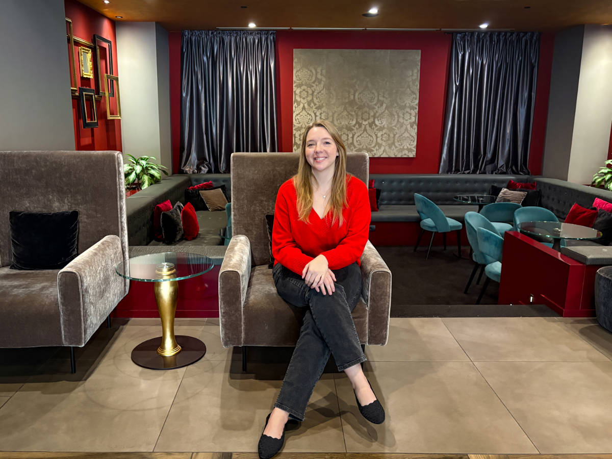 The author, Taylor Herperger sitting on a chair in the lounge area in Leonardo Royal Hotel