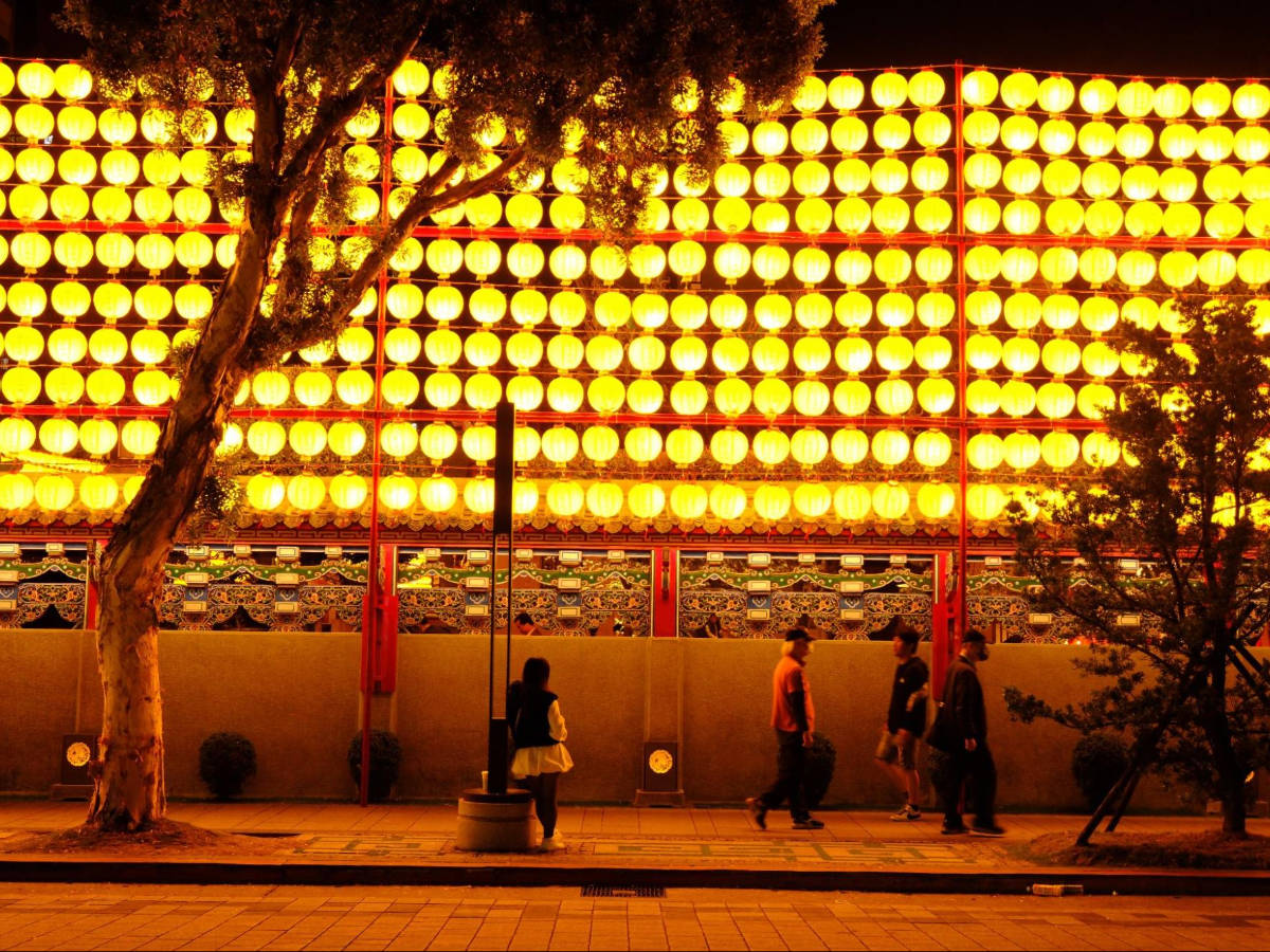 View of lanterns glowing at night in Lungshan Temple