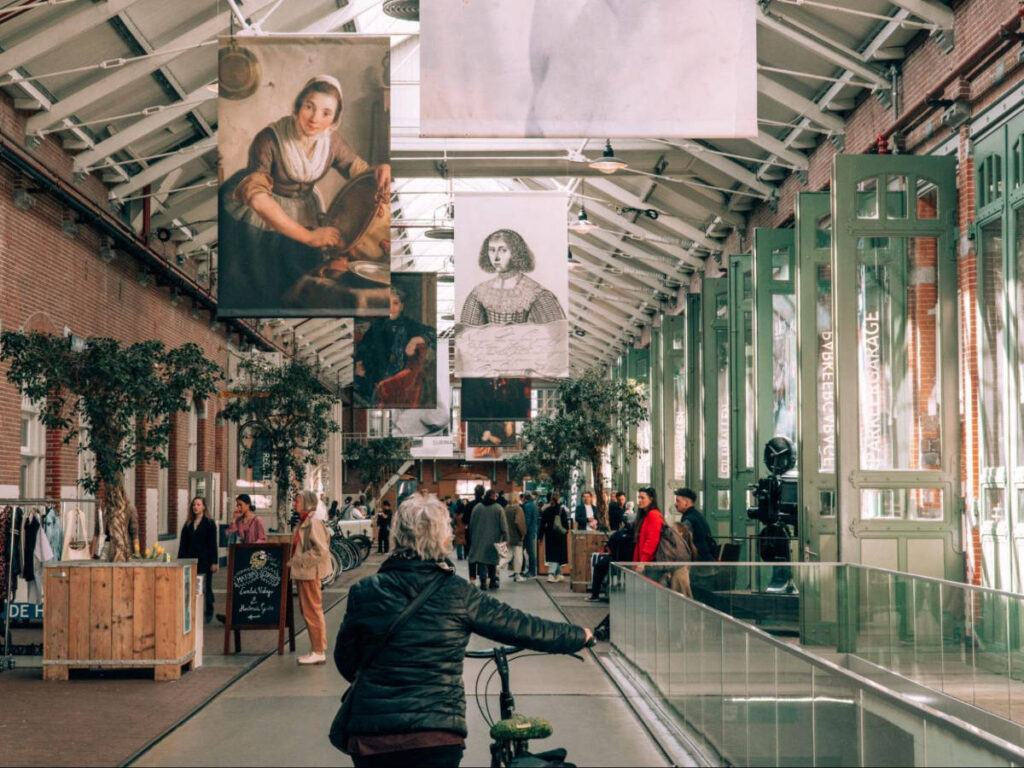 People walking along the main hall of De Hallen