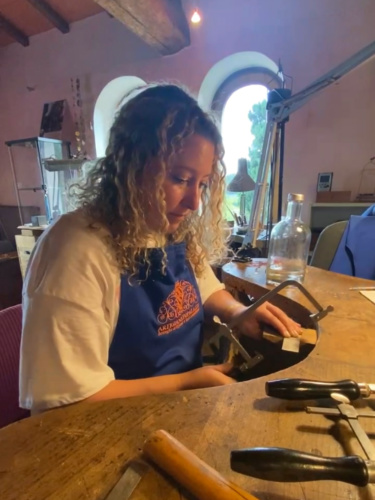 Author Jess sawing a metal at Schmuck Studio in San Casciano