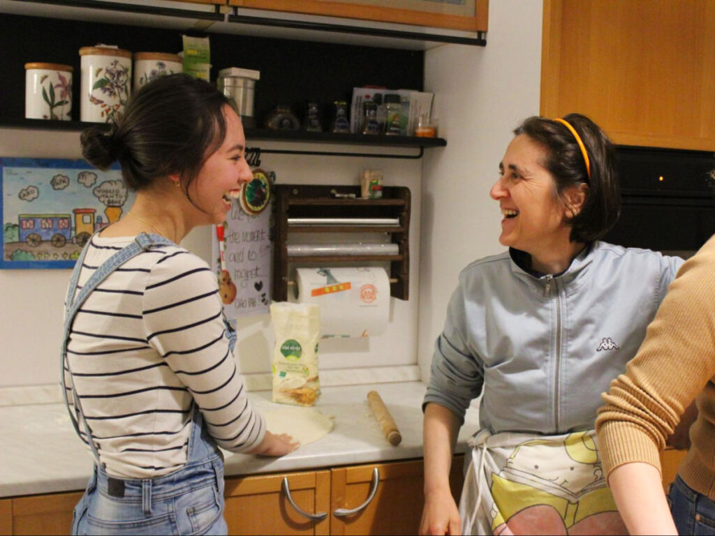 Author Lea Rose Allbaugh making pizza with her language exchange partner’s family in Italy