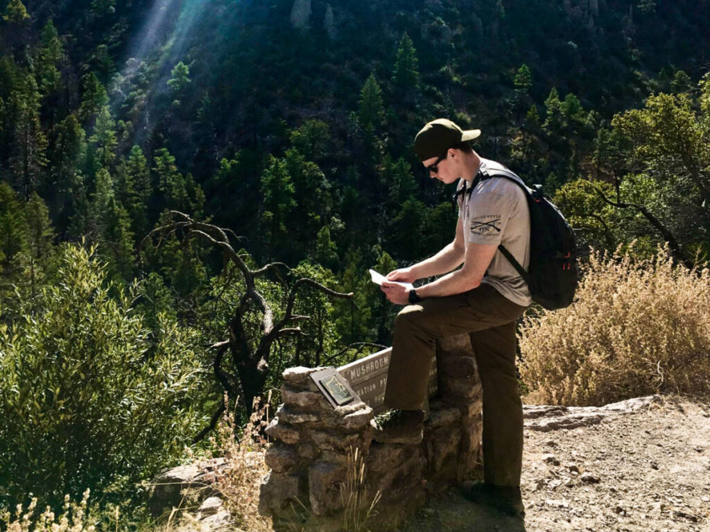 A man looking at the map on the trail
