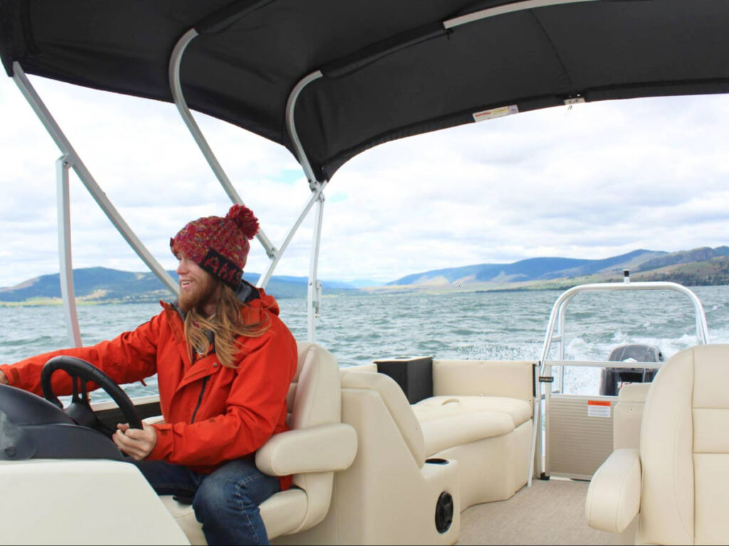 Travel Lemming Abigail's husband driving the boat on Flathead Lake
