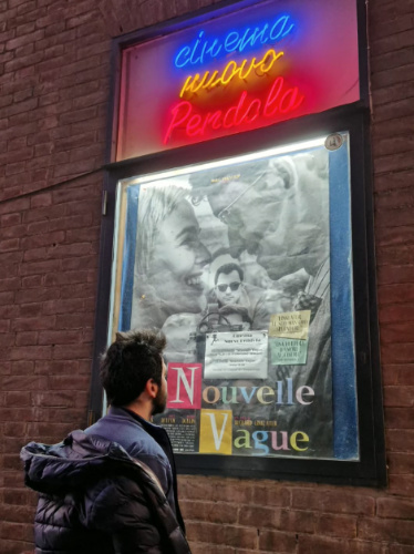 A man closely looking at a movie poster