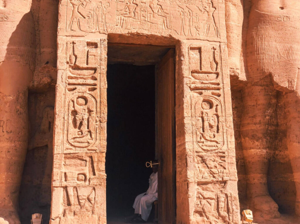 A man sitting at the entrance of Abu Simbel