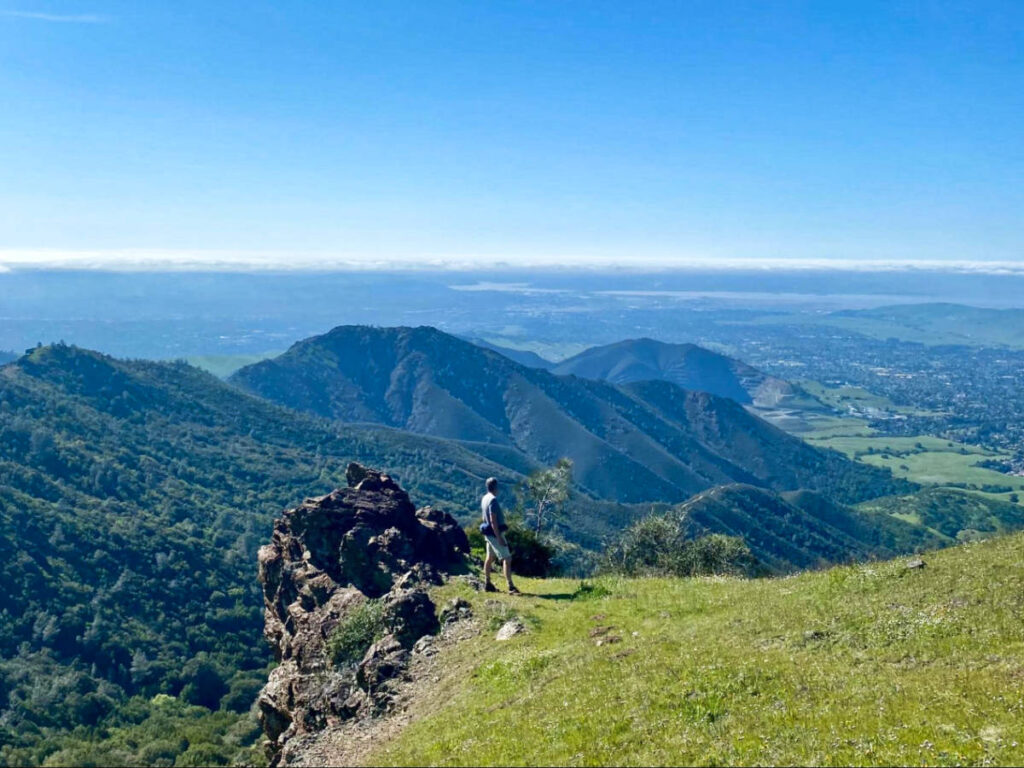 A man enjoying the overlooking view from the Summit Trail