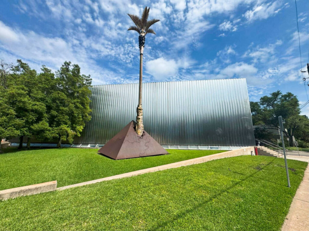 View of the Manilla Palm sculpture by Mel Chin on the grassy field