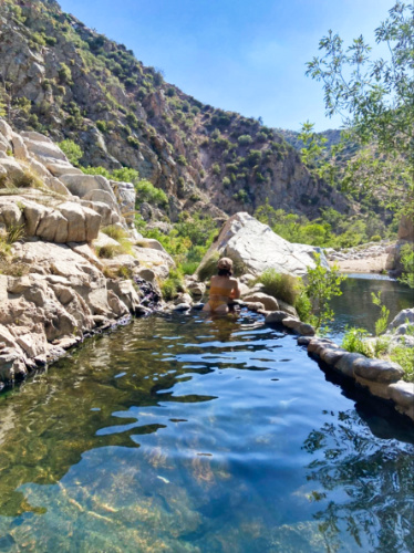 The author McKenna Mobley, enjoying the view while soaking on the water of Deep Creek Hot Springs