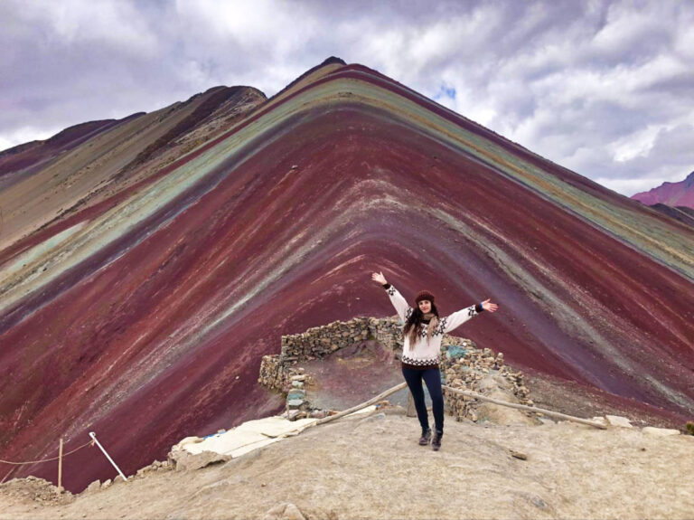 The author Mckenna Mobley, posing in front of the Rainbow Mountain