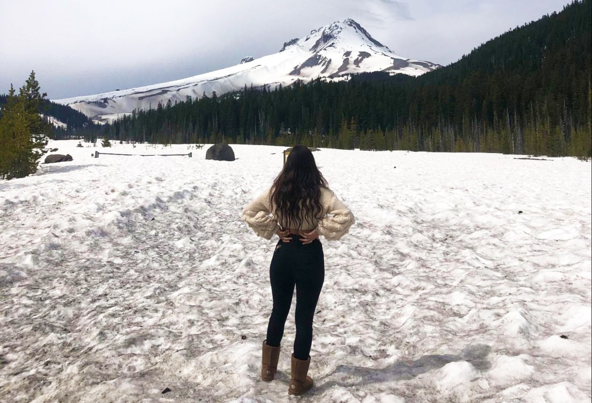 Travel Lemming Writer, McKenna looking at the Mount Hood Summit in the distance during winter