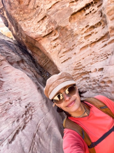 The author McKenna Mobley, posing at the narrow slot canyon