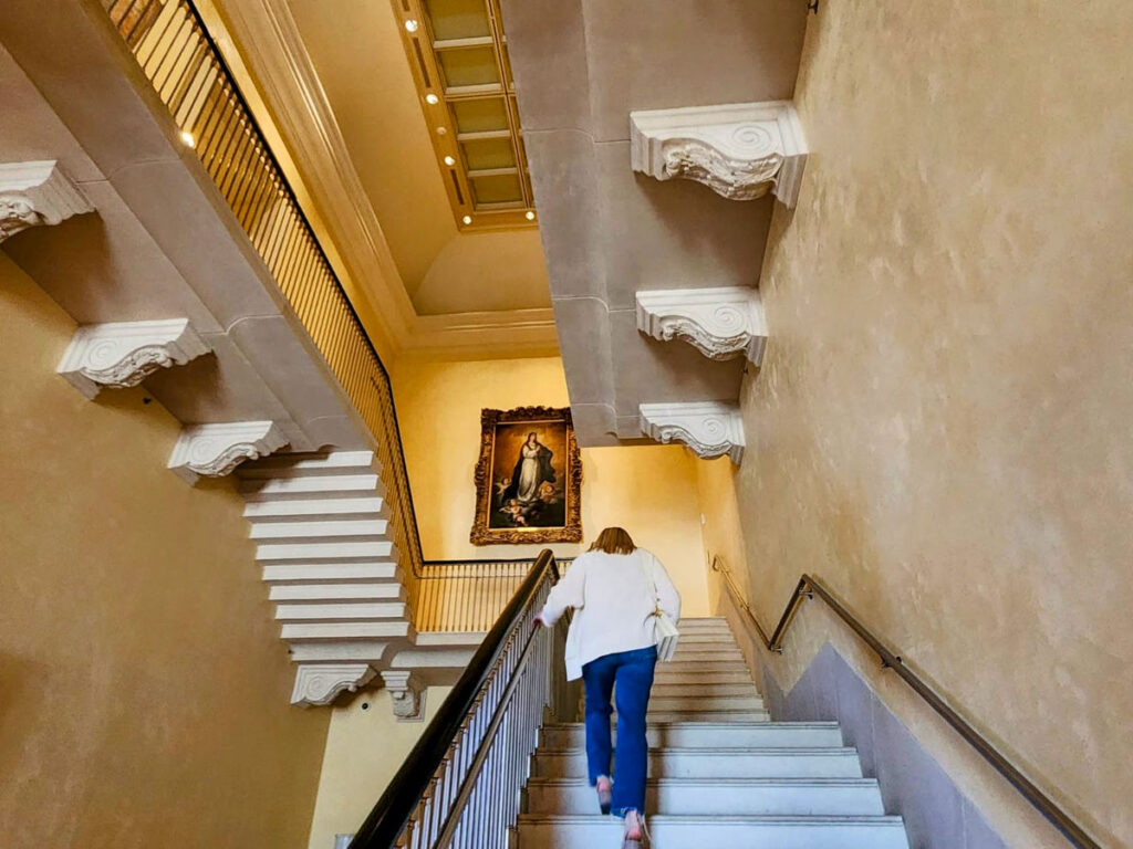 Author Sarah Heath ascending the stairs at Meadows Museum, Dallas