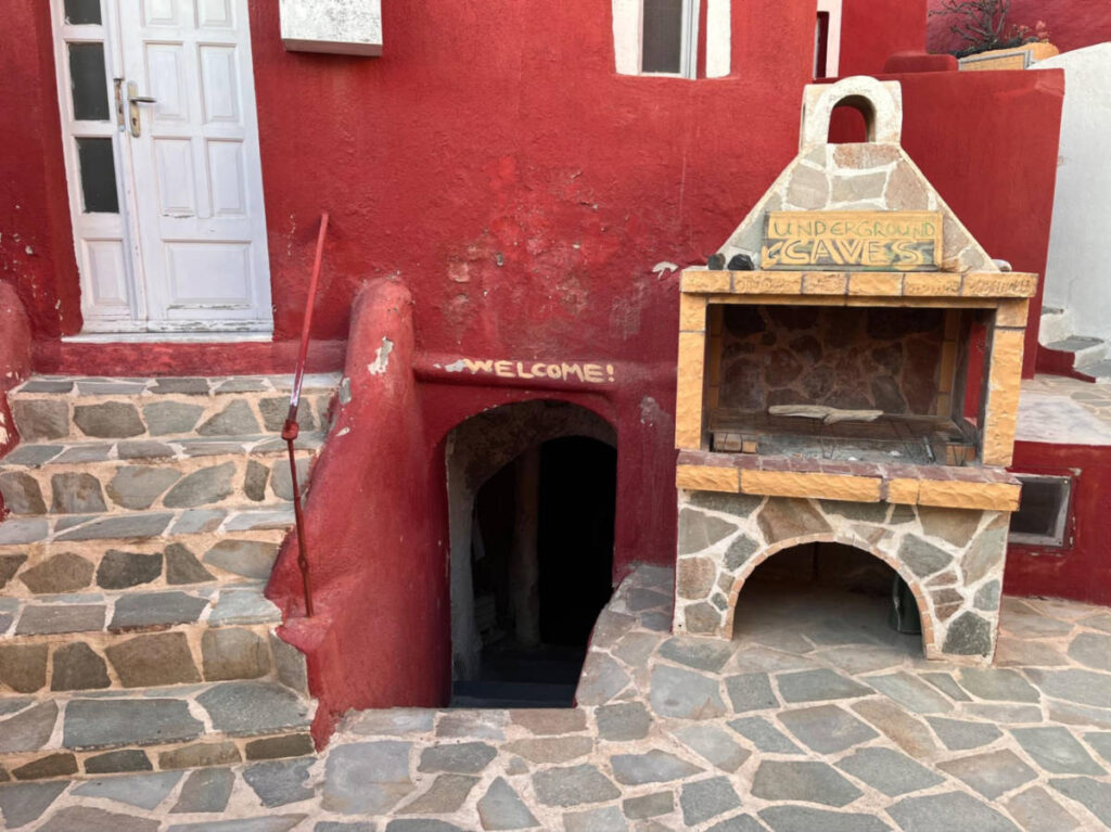 View of the red entryway of the underground cave in Megalochori