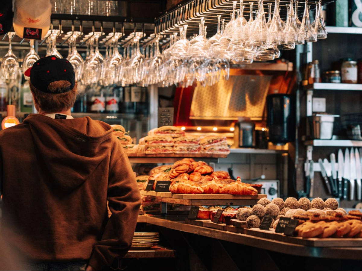 A man looking at the foods in Melqvist Café & Bar