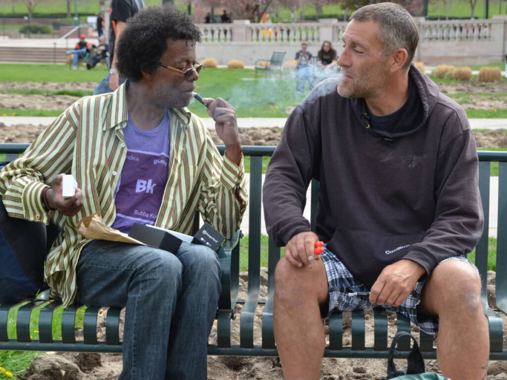 Men sitting on a chair at Civic Center Park
