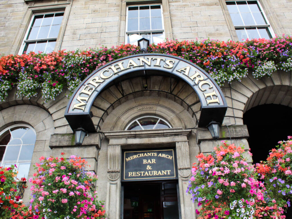 View of the exterior of Merchant's Arch surrounded by flowers