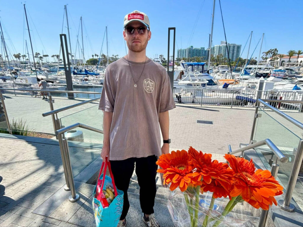 Michael holding a bag of grocery at the Marina Trader Joe’s