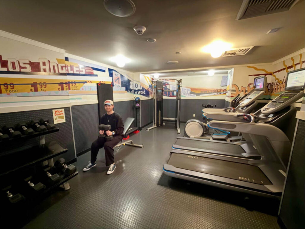 The author's boyfriend, Michael, testing out the weights in the basement gym