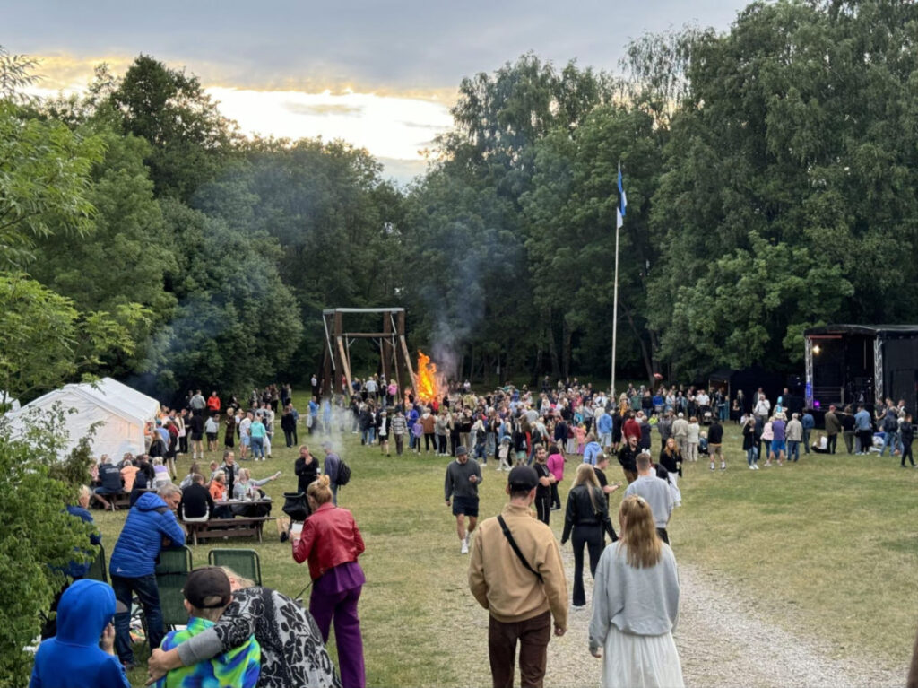 Locals gather by the bonfire for Midsummer celebrations on the island of Hiiumaa
