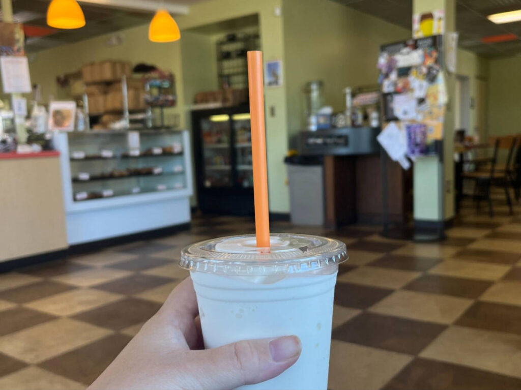 Closeup look of a hand holding a cup of drink at Sip