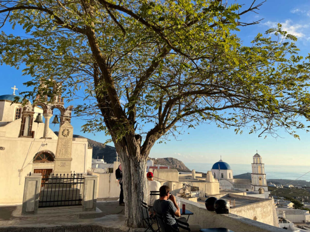 People chilling at the miniature park near the whitewashed buildings and Kasteli of Pyrgos in Santorini