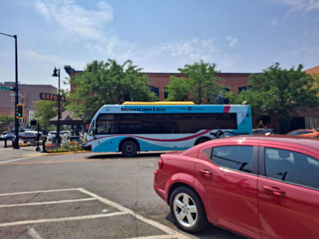 A blue Mountain Line bus on the road