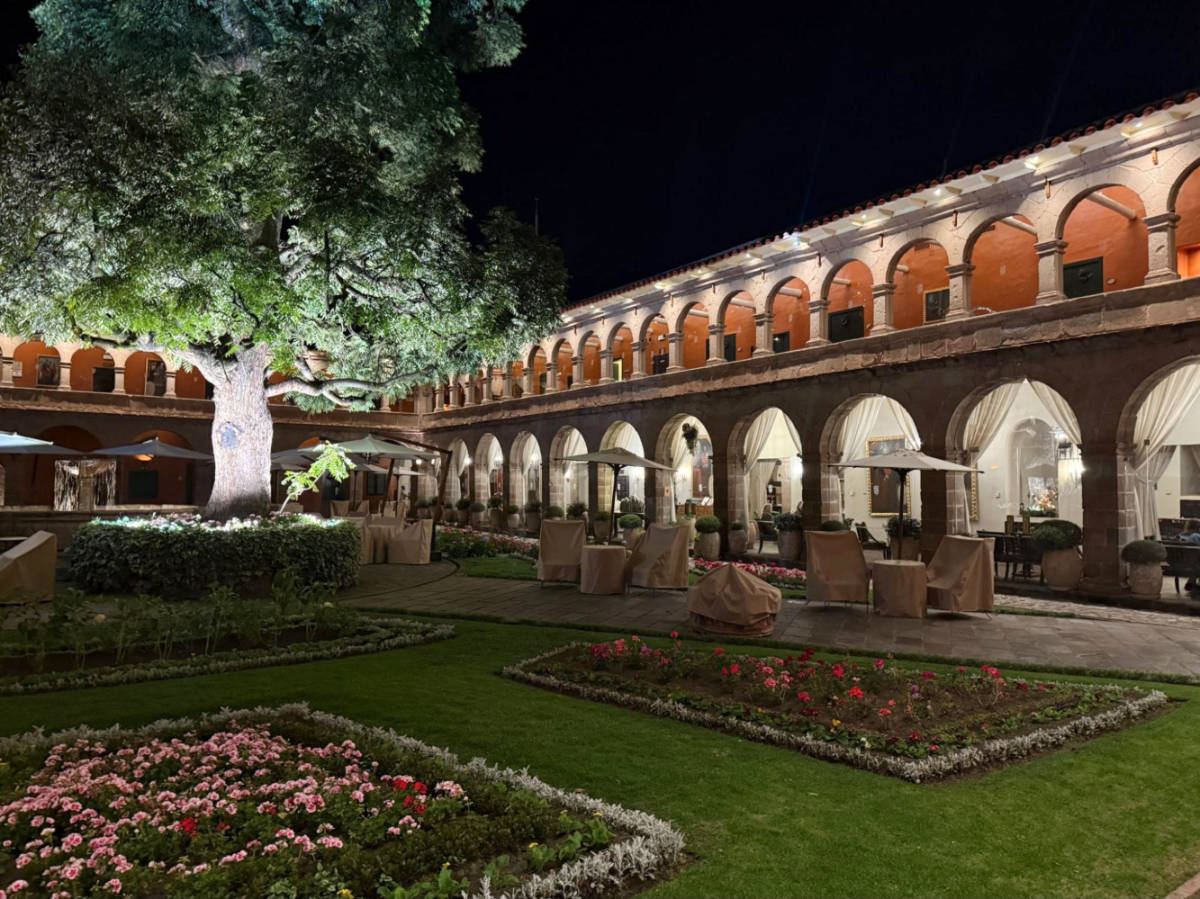 View of the garden and the archways and windows of Monasterio, A Belmond Hotel at night