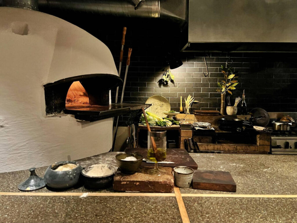 View of the brick-oven from the counterside in Monk Pizza