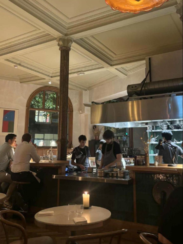 View of the people and the interior with open kitchen dining concept at Morchella