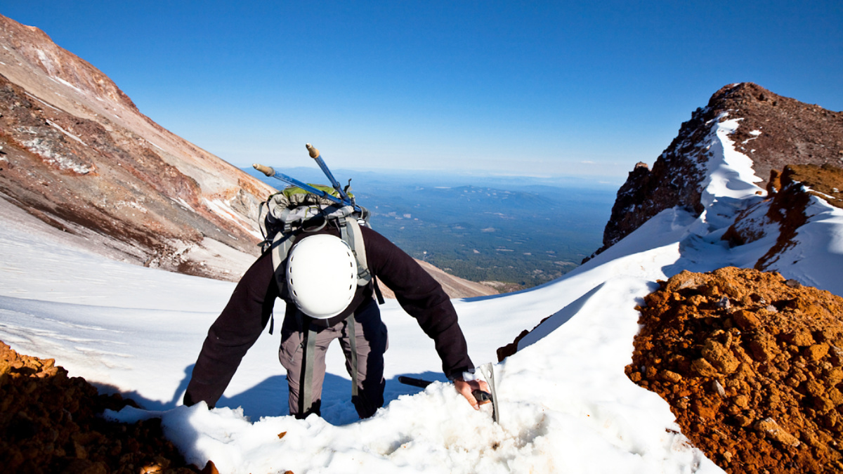 A mountaineer climbing on the steep trail in Mount Shasta during winter