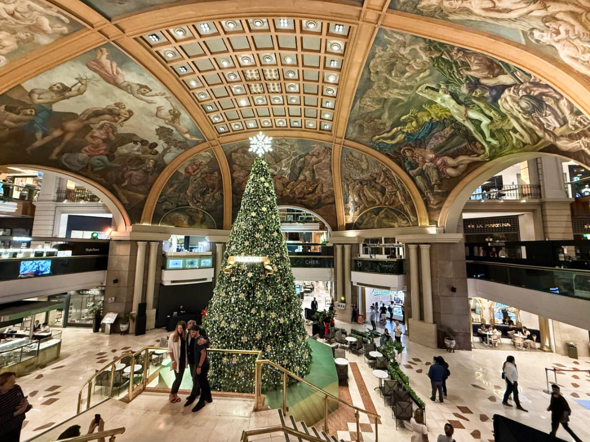 View of the mural on the ceiling and the holiday decorations inside Galerías Pacífico