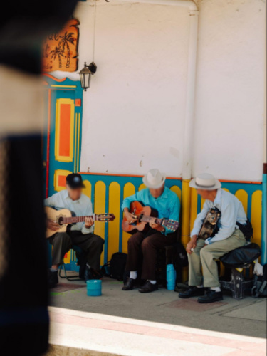 The local street musicians playing their instruments along the street in Salento