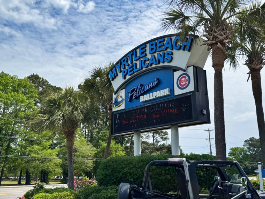 The signage of Myrtle Beach Pelicans surrounded by greenery