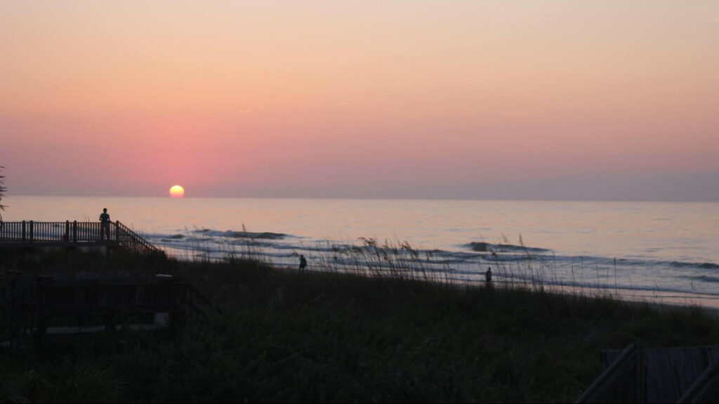 people watching the scenic view of the sunrise at the Myrtle Beach