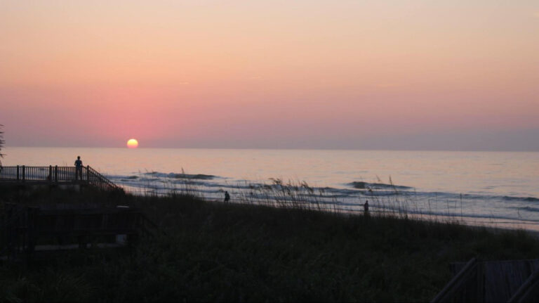 people watching the scenic view of the sunrise at the Myrtle Beach