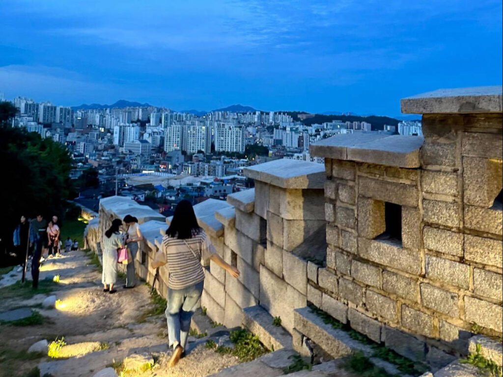 Overlooking skyline views from the Naksan Seoul City Wall at night