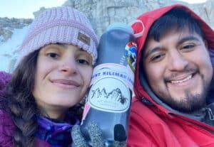 The author smiling for a selfie with her friend while holding her Nalgene Water Bottle