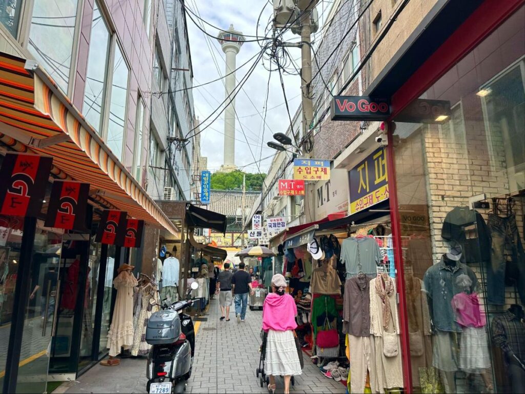 People walking along the vintage shopping stalls in the backstreets of Nampo-dong