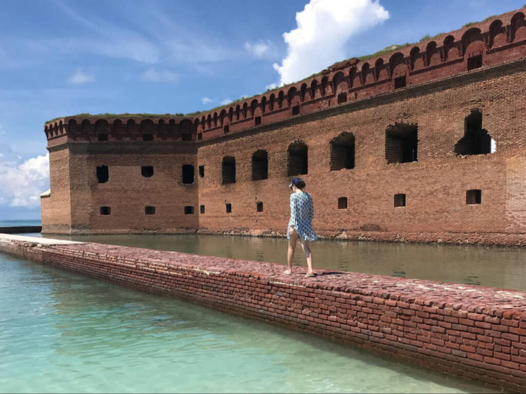 The author Natalie Becerra walking along a pathway at the Fort Walls