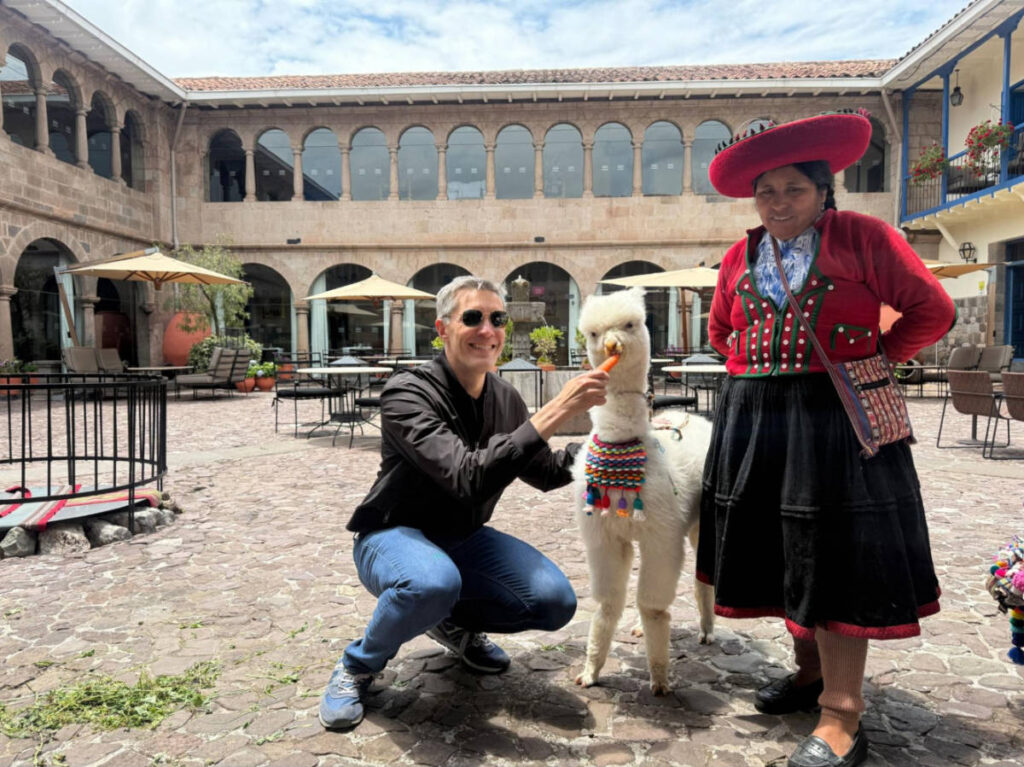 Travel Lemming founder Nate Hake, feeding the resident alpaca at Palacio del Inka