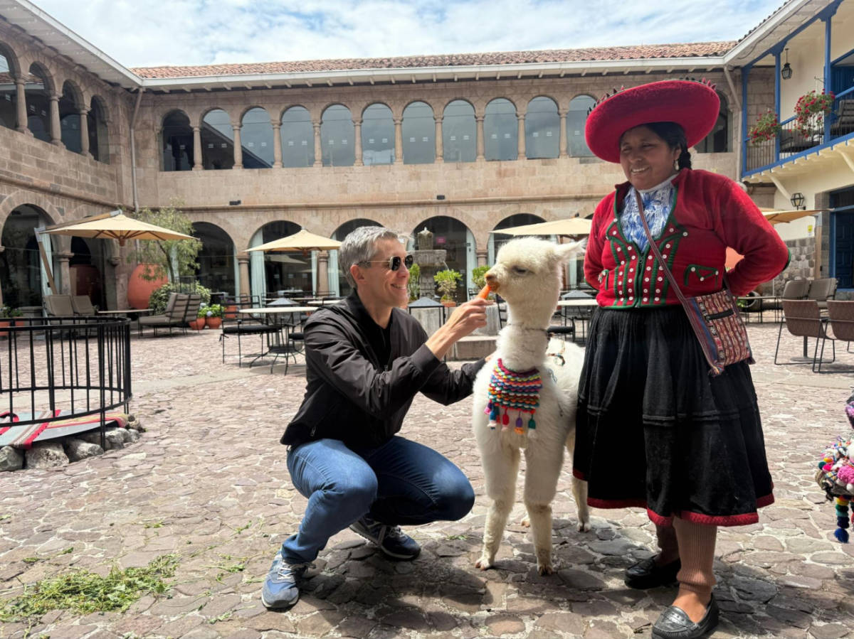 Travel Lemming founder Nate Hake, feeding the resident alpaca at Palacio del Inka