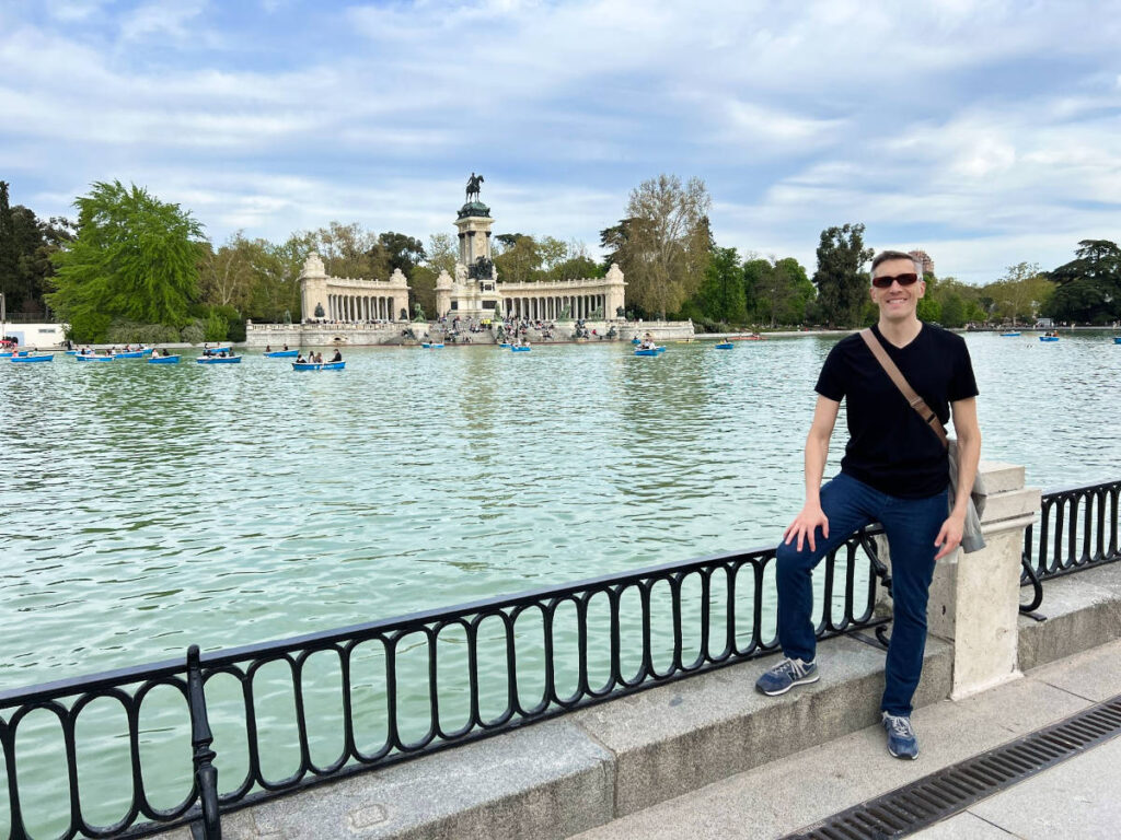 Travel Lemming’s founder Nate Hake at El Retiro Park with paddleboats in the background