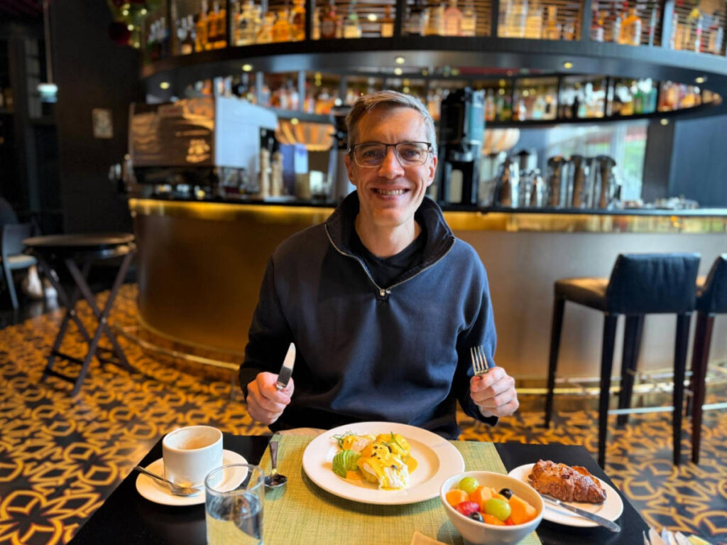 The author, Nate Hake smiling for a photo during their breakfast at Social Restaurant