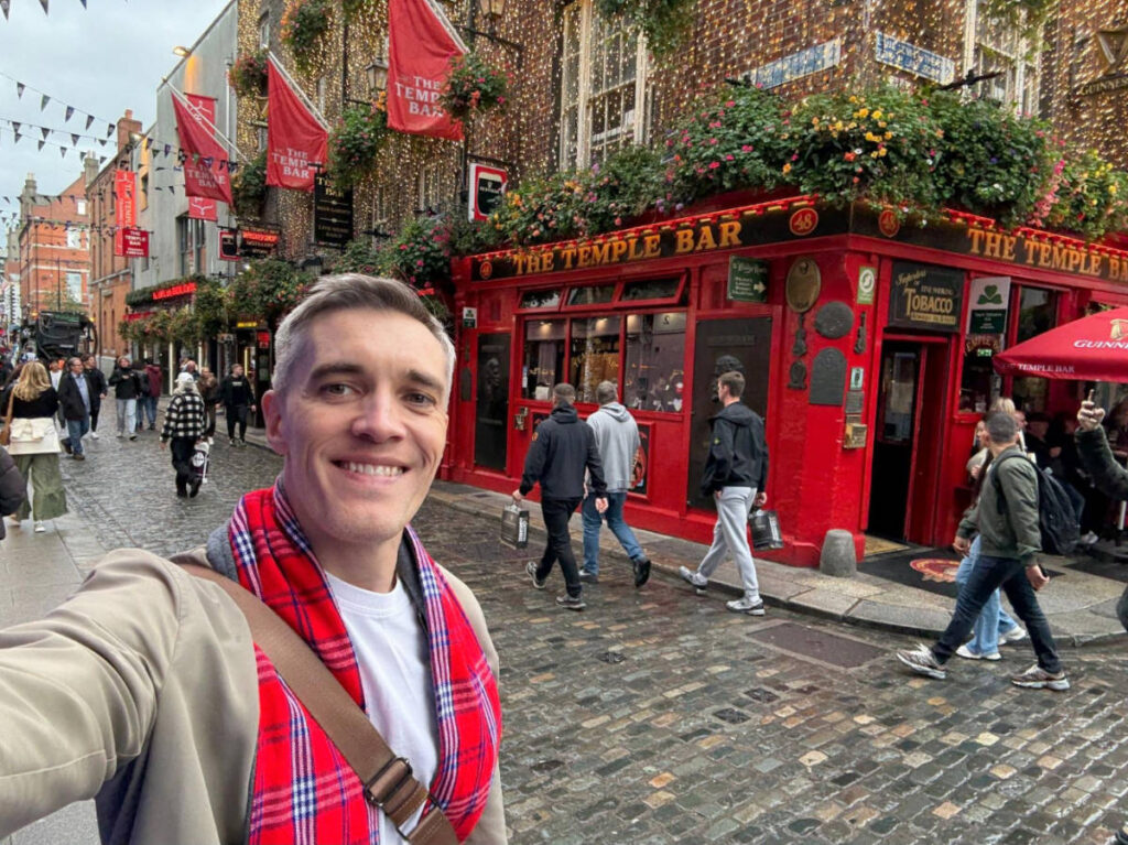 Nate Hake smiling for a selfie outside The Temple Bar
