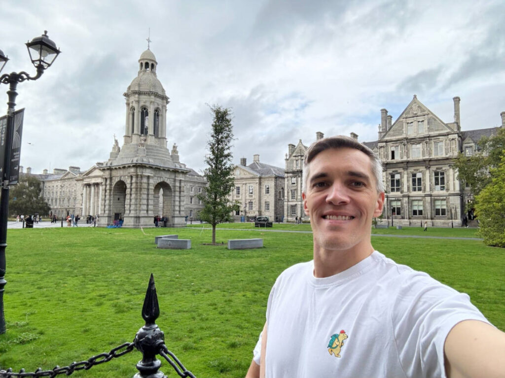 Nate Hake smiling for a selfie at the Trinity College